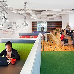 A person sitting at a table with a laptop.