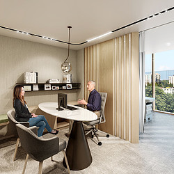 A man and a woman sitting at a table with a laptop.