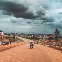 A person riding a motorcycle on a dirt road.