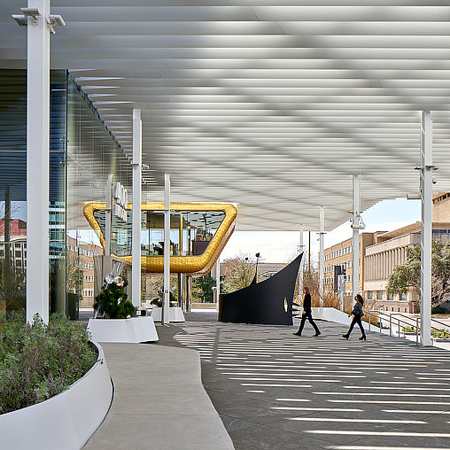 A person walking in a courtyard.