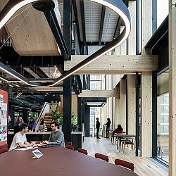 People sitting at tables in a building.