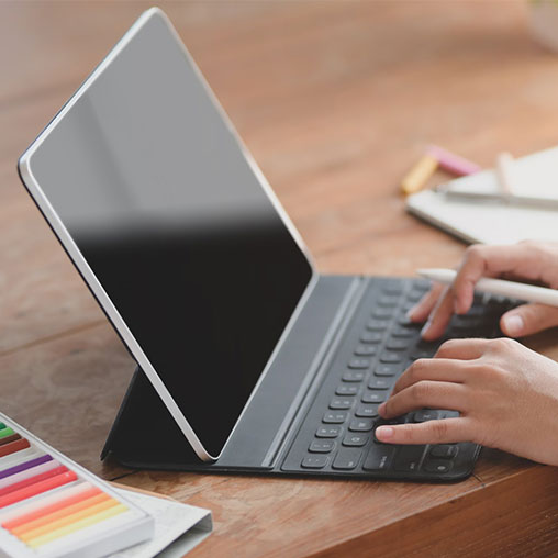 A person holding a laptop.