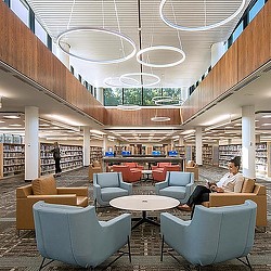 A person sitting in a lounge chair.