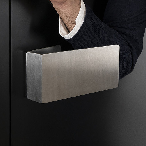 A hand holding a rectangular object.