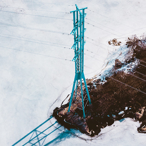 A blue metal tower in the snow.