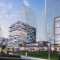 A group of people walking around a large building.