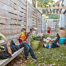 A group of people sitting on the ground outside.