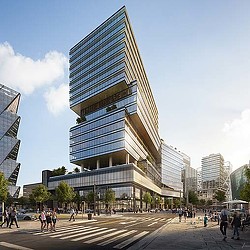 A tall building with people walking around.