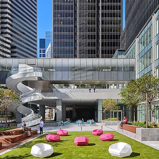 A courtyard with a building in the background.