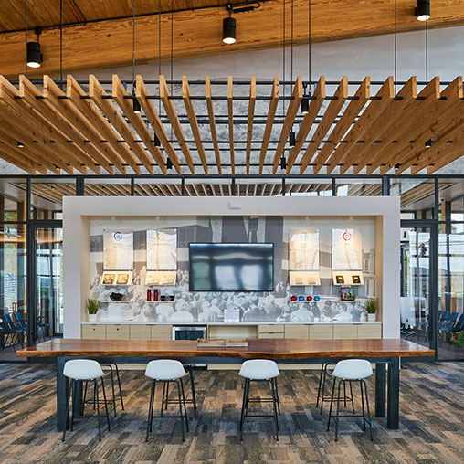 A room with a bar and stools.