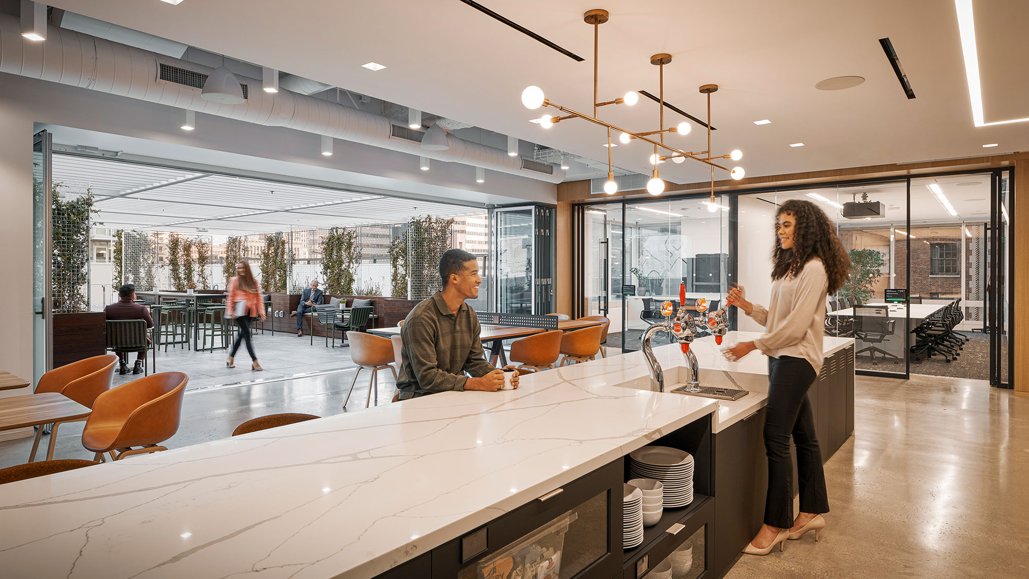 People gather inside a work cafe and dining area.