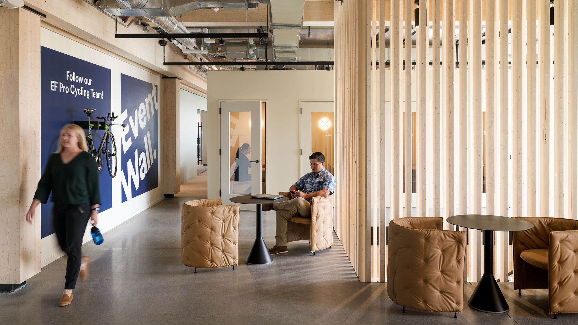 People working in a variety of focus and collaboration spaces.