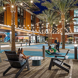 A person sitting on a bench next to a pool.