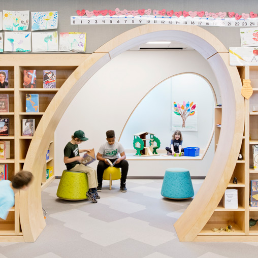 A group of people sitting in a room with a slide.