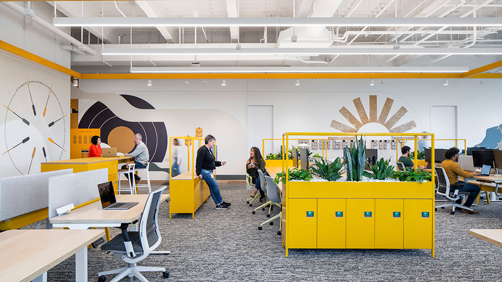 People socialize inside a branded workplace.