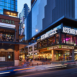 Fifth + Broadway nighttime street view with Assembly Food Hall