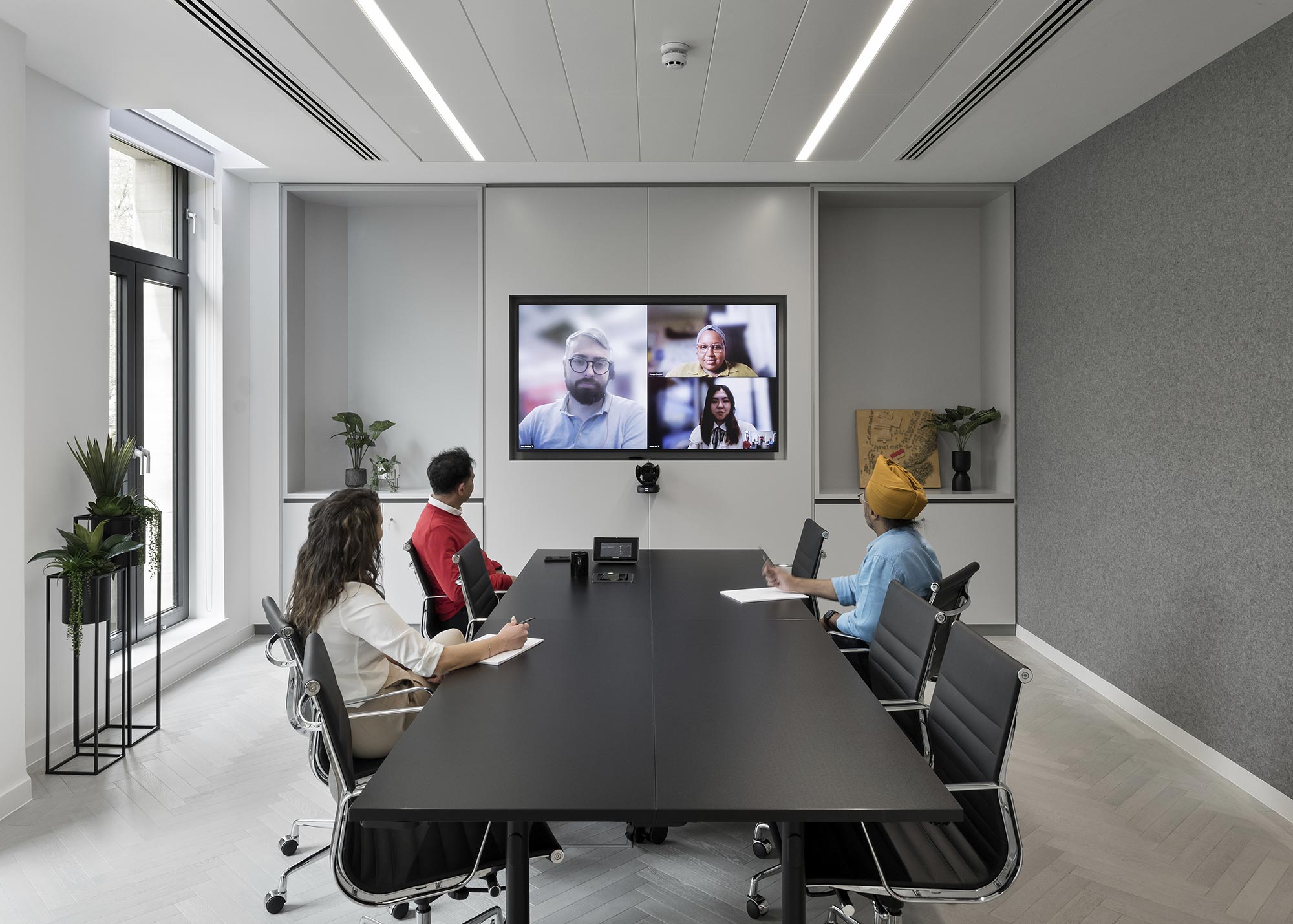 Employees in a hybrid meeting in No. 4 Gensler Birmingham conference room