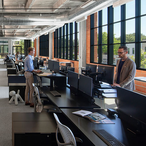 Men standing in an office.