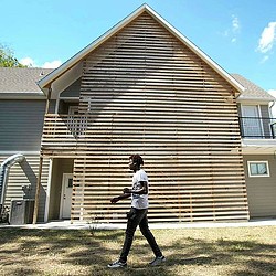 Travis Manning walking in the yard outside Covenant House shelter. Credit: Brett Coomer/Houston Chronicle.