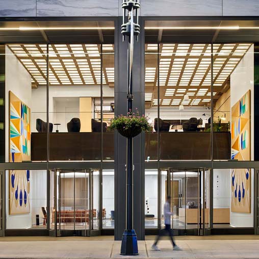 A large metal pole with a plant on it.