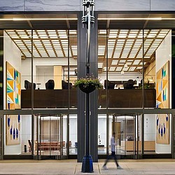 A large metal pole with a plant on it.