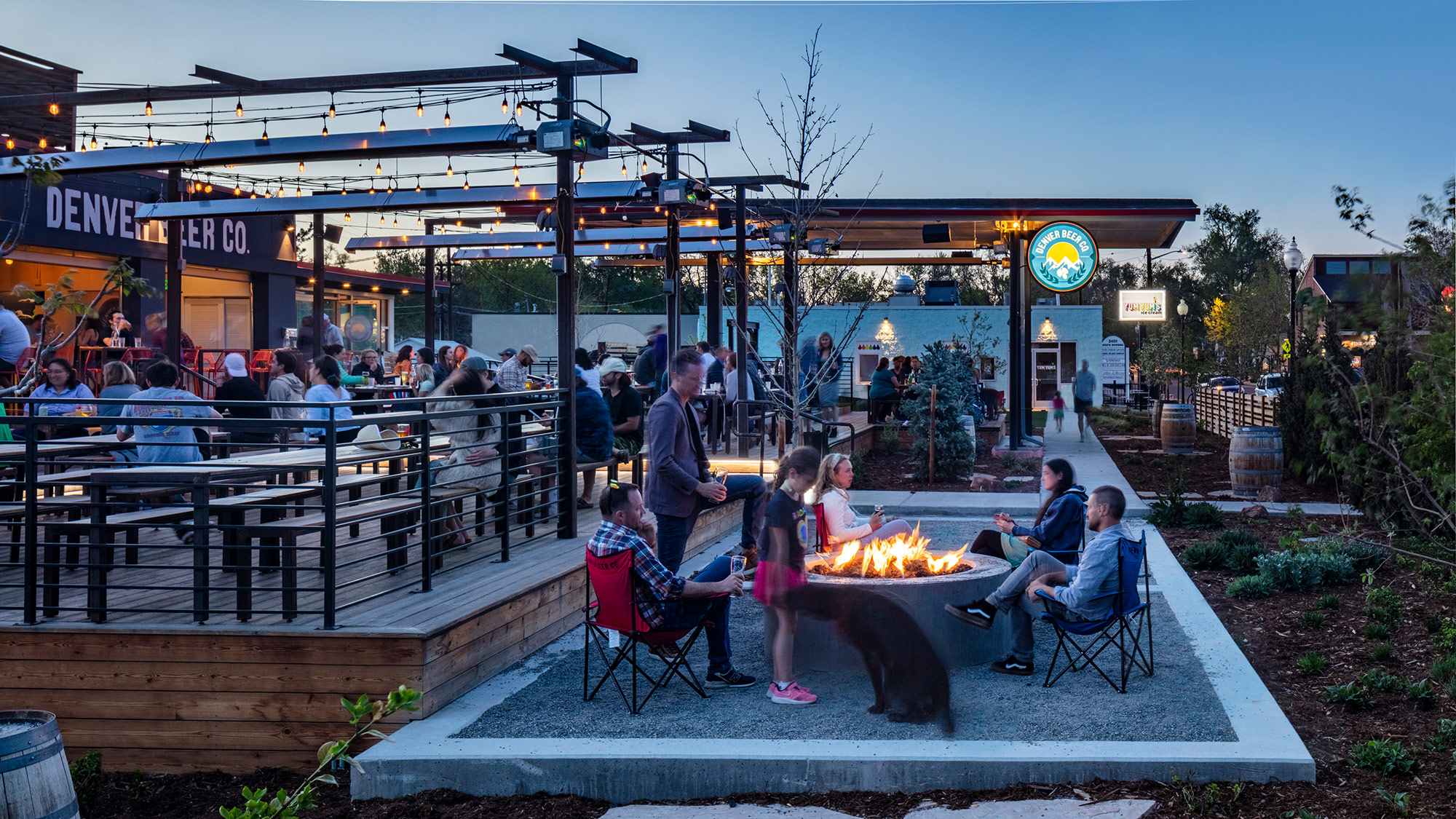 A group of people around a fire pit.
