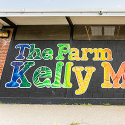 A wall with a colorful mural that reads "The Farm at Kelly Miller"