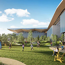 A group of people playing in a grassy area next to a building.