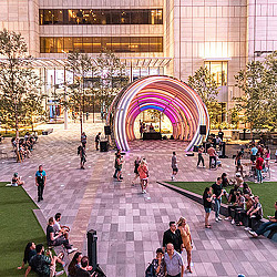 A group of people walking around a building.