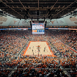 A basketball court with a crowd of people in the stands.