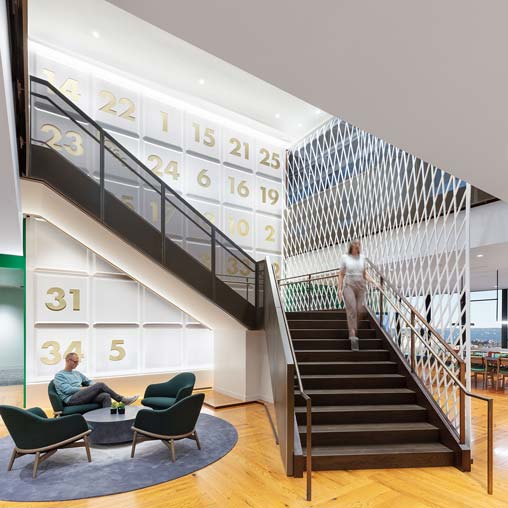 Interconnecting staircase adjacent to open collaboration space in the Celtics workplace
