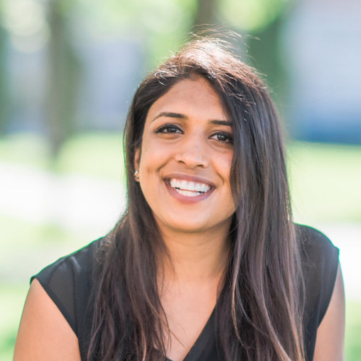 A woman with long hair smiling.