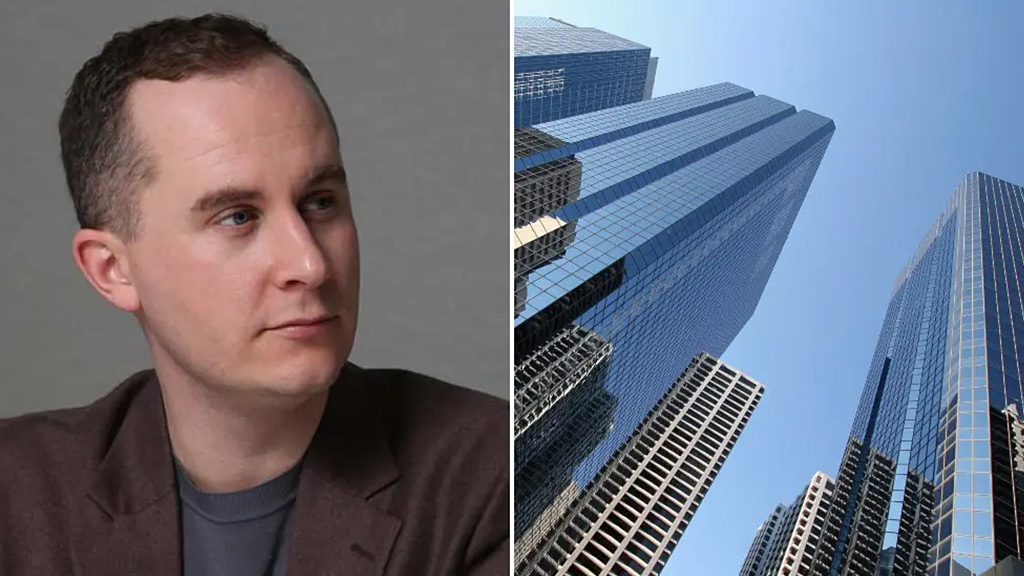 A man standing in front of a group of skyscrapers.