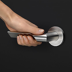 A hand holding a silver object.