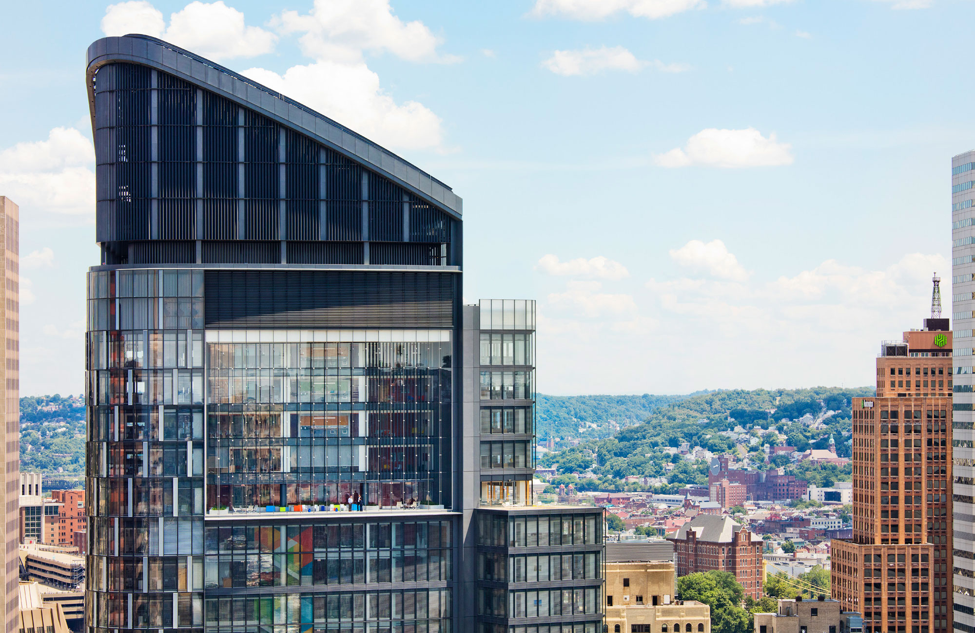 A high rise building with a city in the background.