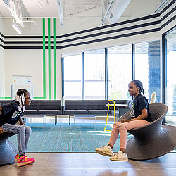 An open community space with large windows and children playing at Big Brothers Big Sisters Minneapolis