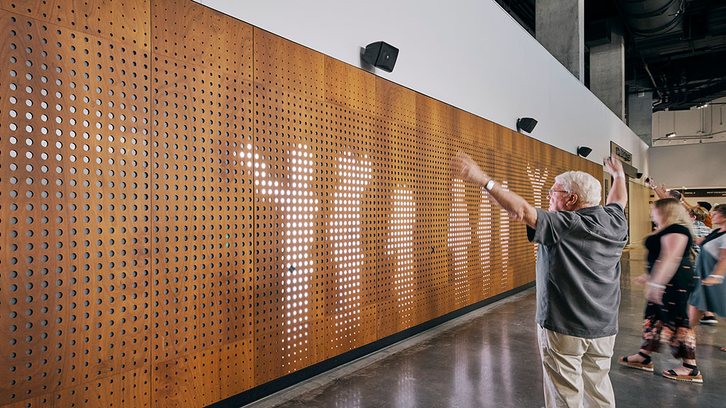 A man standing next to a wall.