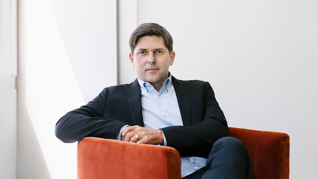 Benjy Ward from Gensler Chicago sitting in a burnt orange velvet chair