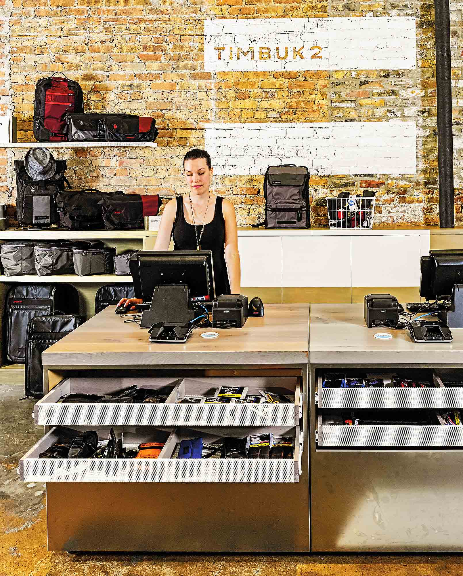 A person standing behind a counter with a camera and a camera on it.