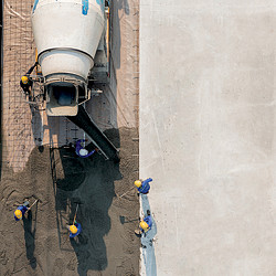 A group of people standing in a puddle of water.