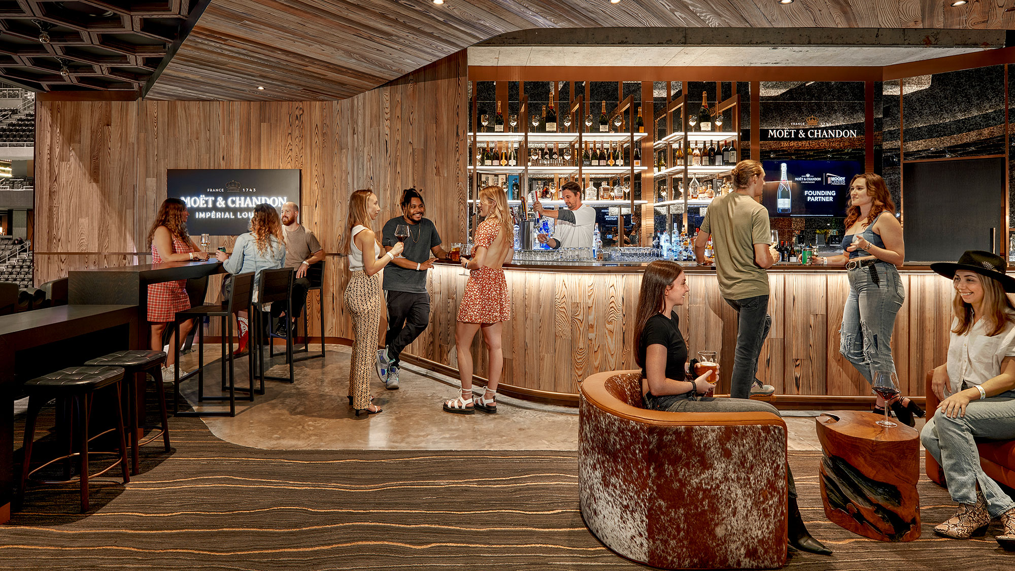A group of people standing in a bar.