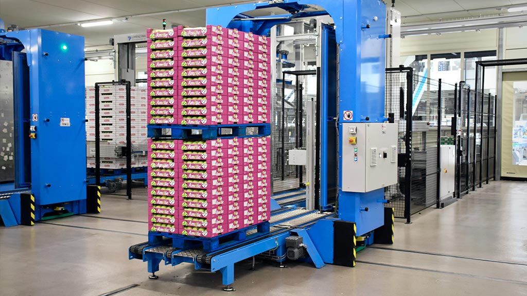 Fulfillment center with pink apple boxes. Credit: Arno Senoner via Unsplash