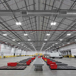 A large warehouse with red chairs.