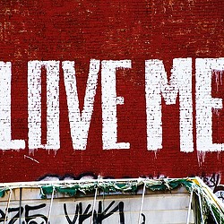 Love Me on brick wall in Tribeca. Credit: Unsplash