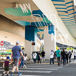 A group of people walking on a street.