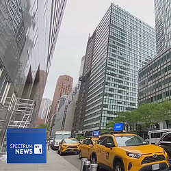 New York streetscape with taxis and NY1 logo