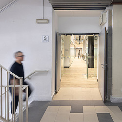 A person standing in a hallway in a Singapore workspace.