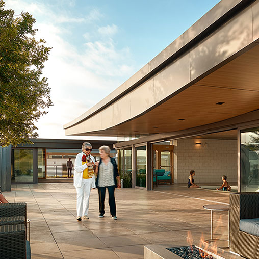 A man and woman standing outside a building.