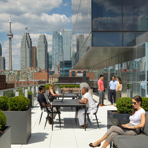 People sitting at a table in front of a city.