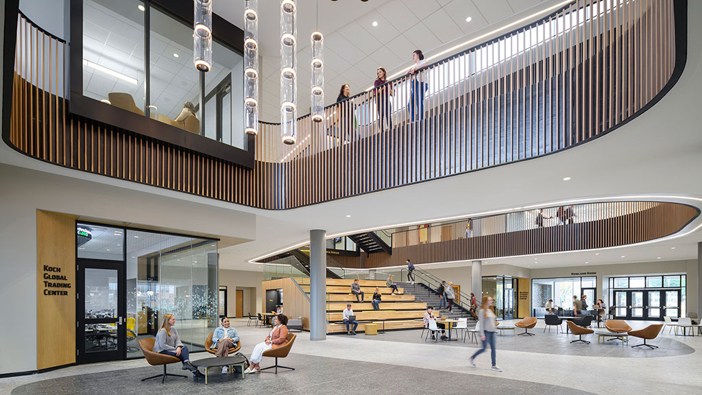 People sitting on benches in a building.